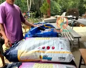 Bags of cat and dog food unloaded and stacked on a table